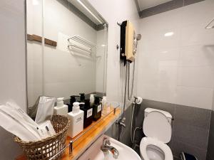 a bathroom with a toilet and a sink and a mirror at 25Studio House - District 1 in Ho Chi Minh City