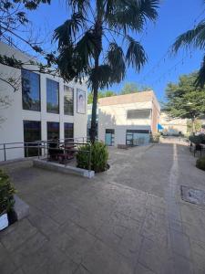 a building with a palm tree in front of it at Levels Executive Residences in Manila +28 photos