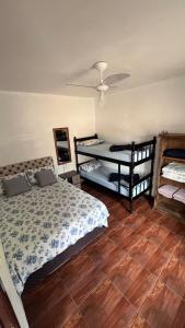 a bedroom with two beds and a ceiling fan at Pousada Pier 123 in Penha +47 photos