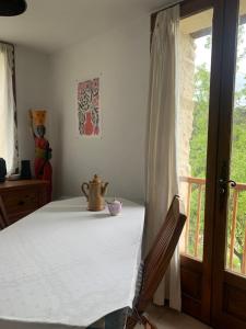 a bedroom with a table with a tea pot on it at La Petite Prairie in Briançonnet