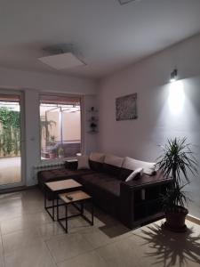 a living room with a couch and a table at Alexandria Lux Apartments in Karpoš Dva