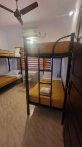 two bunk beds in a room with a ceiling at Happy Seas Beach Villa in Alleppey +22 photos