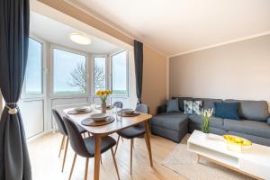 a living room with a table and a couch at Appartement Cappel Whg 16 in Cappel-Neufeld