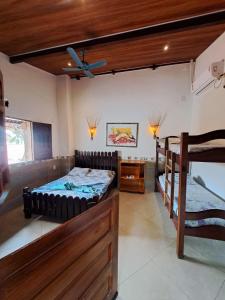 a room with two bunk beds and a desk at Pousada Aguas Marinhas in Cabo de Santo Agostinho