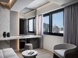 a living room with two chairs and a table at Nur Edge Aparthotel - Acropolis Skyline in Athens