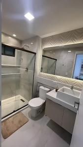 a bathroom with a toilet and a shower and a sink at Flat Porto Blue 104 - Centro Porto de Galinhas in Porto De Galinhas