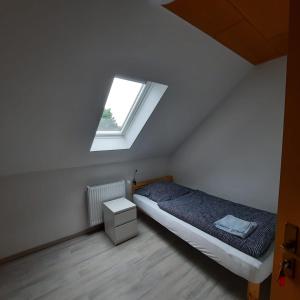 a bedroom with a bed and a window at LivingRoom GmbH Raf1 Apartment in Salzgitter und Umgebung in Salzgitter +3 photos