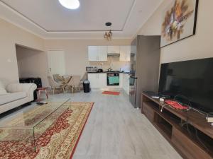 a living room with a large flat screen tv at Sable Suites C1, 1 Bed Apartments in Kabulonga in Lusaka