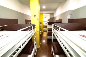 A bed or beds in a room at Madrid Downtown Hostel