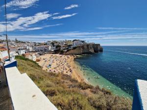 a view of a beach with people in the water at LeComer in Carvoeiro
