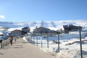 a group of people walking on a snow covered mountain at Estudios Sierra De Francia in Béjar
