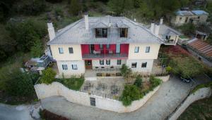 an aerial view of a house with a fence at Horizon Hotel in Ioannina