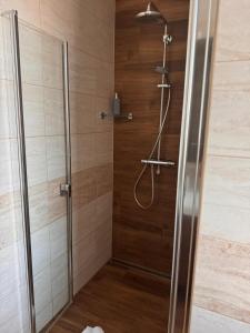 a shower in a bathroom with a glass door at Apartmán RUŽA in Ružomberok +17 photos
