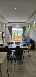 a living room with a table and a couch at Abidjan in Cocody