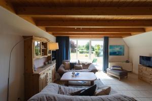 a living room with two couches and a table at Ferienhaus Nordertill 01 in Dorum Neufeld