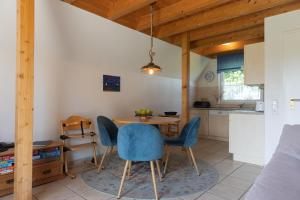 a kitchen and dining room with a table and chairs at Ferienhaus Nordertill 01 in Dorum Neufeld
