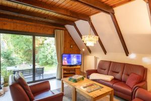 a living room with a couch and a tv at Ferienhaus Robbenplate 11 in Dorum-Neufeld