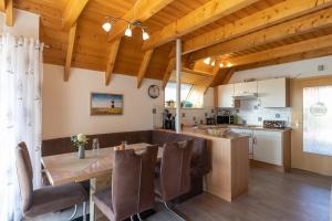 a kitchen and dining room with a table and chairs at Ferienhaus Hans Albers 09 in Wremen +31 photos