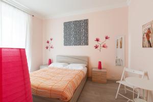 a bedroom with a bed and a desk and a table at San Giovanni Rooms Roma in Rome