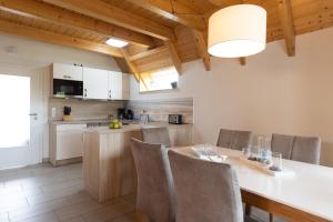 a kitchen and dining room with a table and chairs at Ferienhaus "Glück Auf! I" Mellumplate 25 in Dorum Neufeld