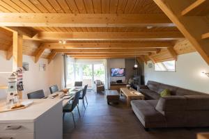 a living room with a couch and a table at Ferienhaus Mellumplate 50 in Dorum Neufeld