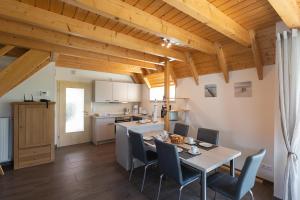 a kitchen and dining room with a table and chairs at Ferienhaus Mellumplate 50 in Dorum Neufeld