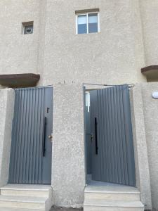two doors on the side of a building at استديو هادئ وأنيق مدخل مستقل in Hail