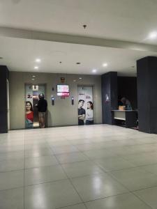 a large room with people standing in a building at Apartemen urban town by NN Room in Karawang