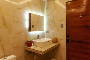 a bathroom with a sink and a mirror at Balai La Niña Beach Resort in Aclan