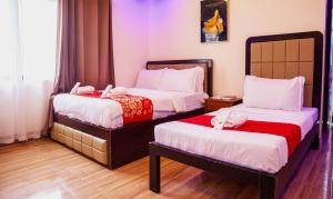 two beds in a hotel room with stuffed animals on them at Balai La Niña Beach Resort in Aclan