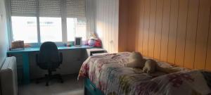 a bedroom with a bed with a stuffed animal on it at Piso zona feria in Albacete