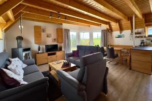 a living room with couches and a kitchen and a table at Ferienhaus "Sprenger" Hans Albers 11 in Wremen