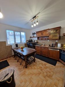 a large kitchen with a wooden table in it at Grande maison 22 couchages ideal groupe ,proche Disney 20 min &Paris 30 min in Chelles