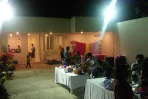 a group of people standing around tables in a room at Casa Sótano, con alberca in Las Delicias