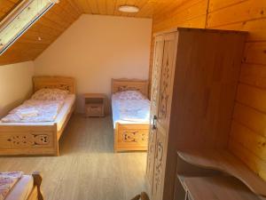 a small room with two beds and a closet at Domek na Stasince in Sidzina +14 photos