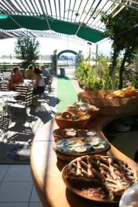 a table with plates of pastries on top at Hotel Vela Velo Club Vieste in Vieste
