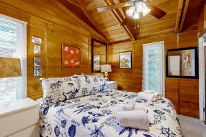 a bedroom with a bed in a room with wooden walls at Dewey Beach - Rehoboth By The Sea --- 102 Chicago St in Dewey Beach
