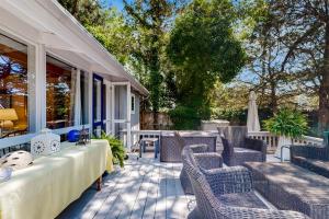 a patio with wicker chairs and tables on a house at Dewey Beach - Rehoboth By The Sea --- 102 Chicago St in Dewey Beach