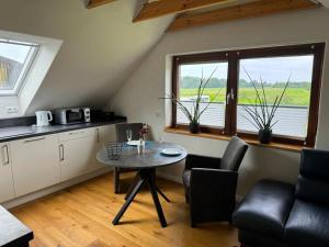 a kitchen with a table and chairs in a room at Grenzblick in Isselburg-Anholt in Isselburg