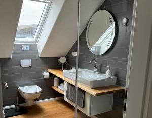 a bathroom with a sink and a mirror at Grenzblick in Isselburg-Anholt in Isselburg +9 photos