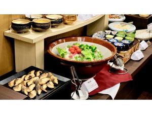 a bowl of vegetables and a bowl of food on a stove at COCOLAND - Vacation STAY 73987v in Ube