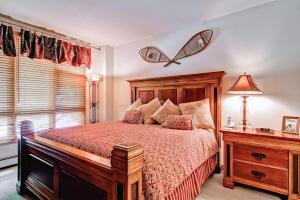 a bedroom with a bed with a butterfly on the wall at Highlands Westview 105 by East West Hospitality in Beaver Creek