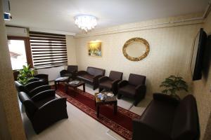 a waiting room with couches and chairs and a mirror at Selimiye Palace in Edirne