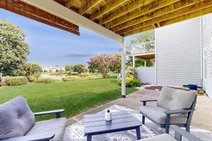 a patio with two chairs and a coffee table on a lawn at Spring Lake --- 38167 West Dr. #716 in Rehoboth Beach