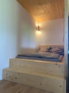 a bed with a wooden frame in a room at Haus 7&50 in Bolsterlang