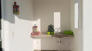 a kitchen with a sink and a counter top at Casa la xulada in Mazunte