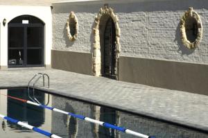 a building with a pool of water with a door at 13 Bella Rosa Apartment in Durbanville
