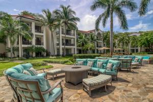 a group of chairs and tables in front of a building at Pacifico TH-104 in Coco