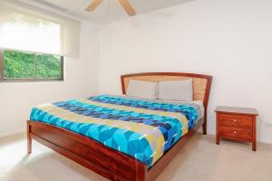 a bedroom with a bed and a night stand and a window at Pacifico TH-104 in Coco +36 photos