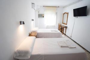 Postel nebo postele na pokoji v ubytování Hostal Residencia Pasaje
